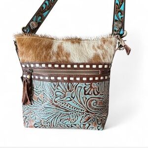 Myra bag is beautiful with a belt strap, embossed leather and hair on leather